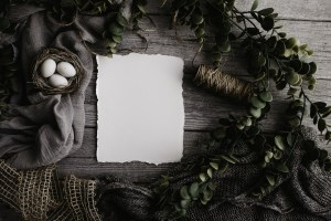 Wooden Table with greenery, bird nest and blank letter